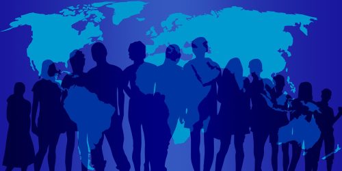 A group of people silhouetted against a map of the world.